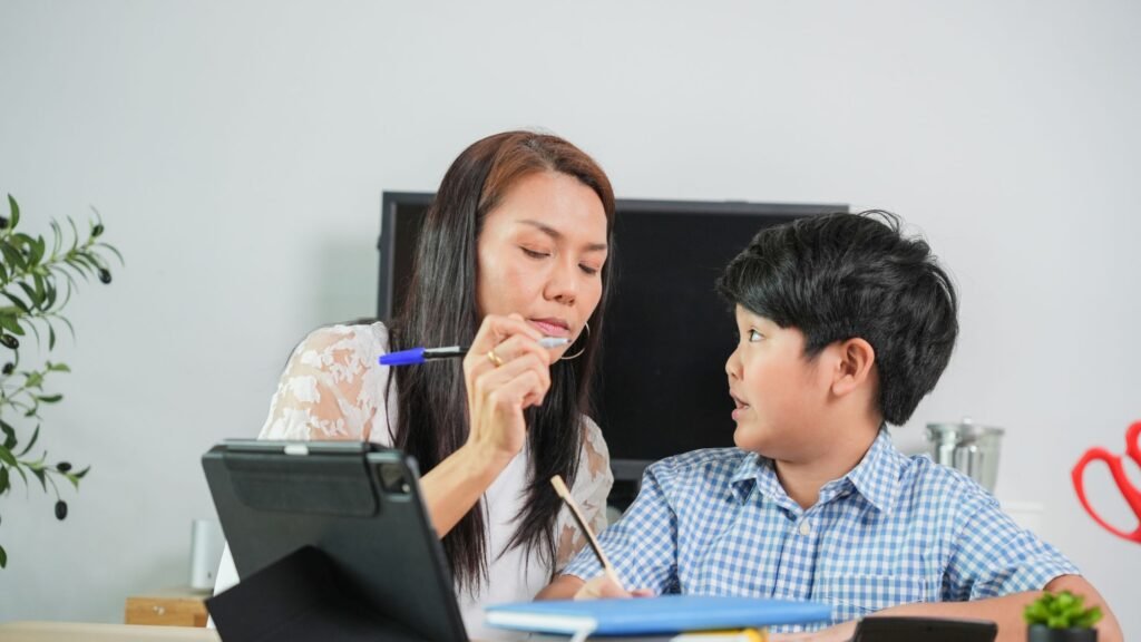 A tutor giving a student one-on-one math help at a desk