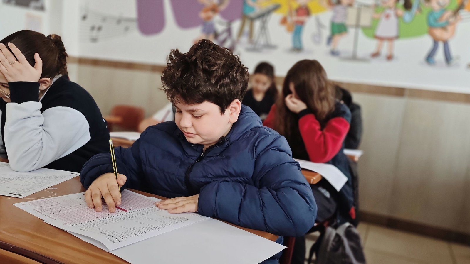 School students working through math problems at their desks during a classroom lesson